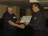 Bob Burton presents Darby Allan with his presentation  